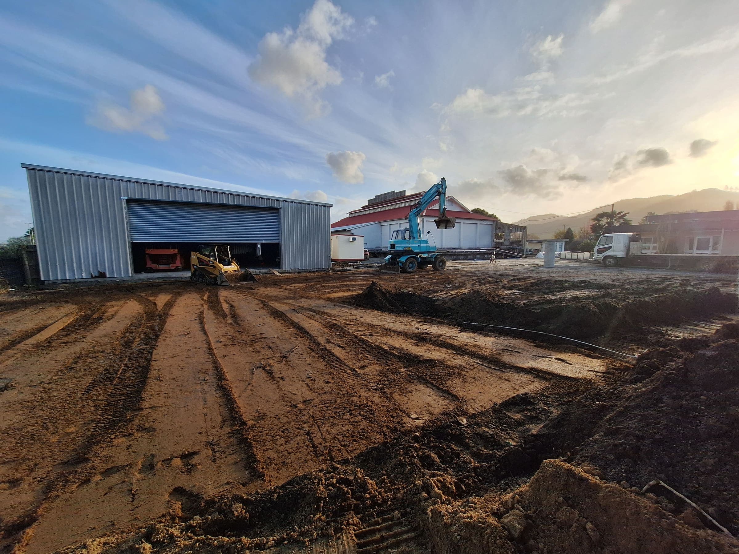 Excavator preparing a commercial site for Tensen Landscapes in Hamilton