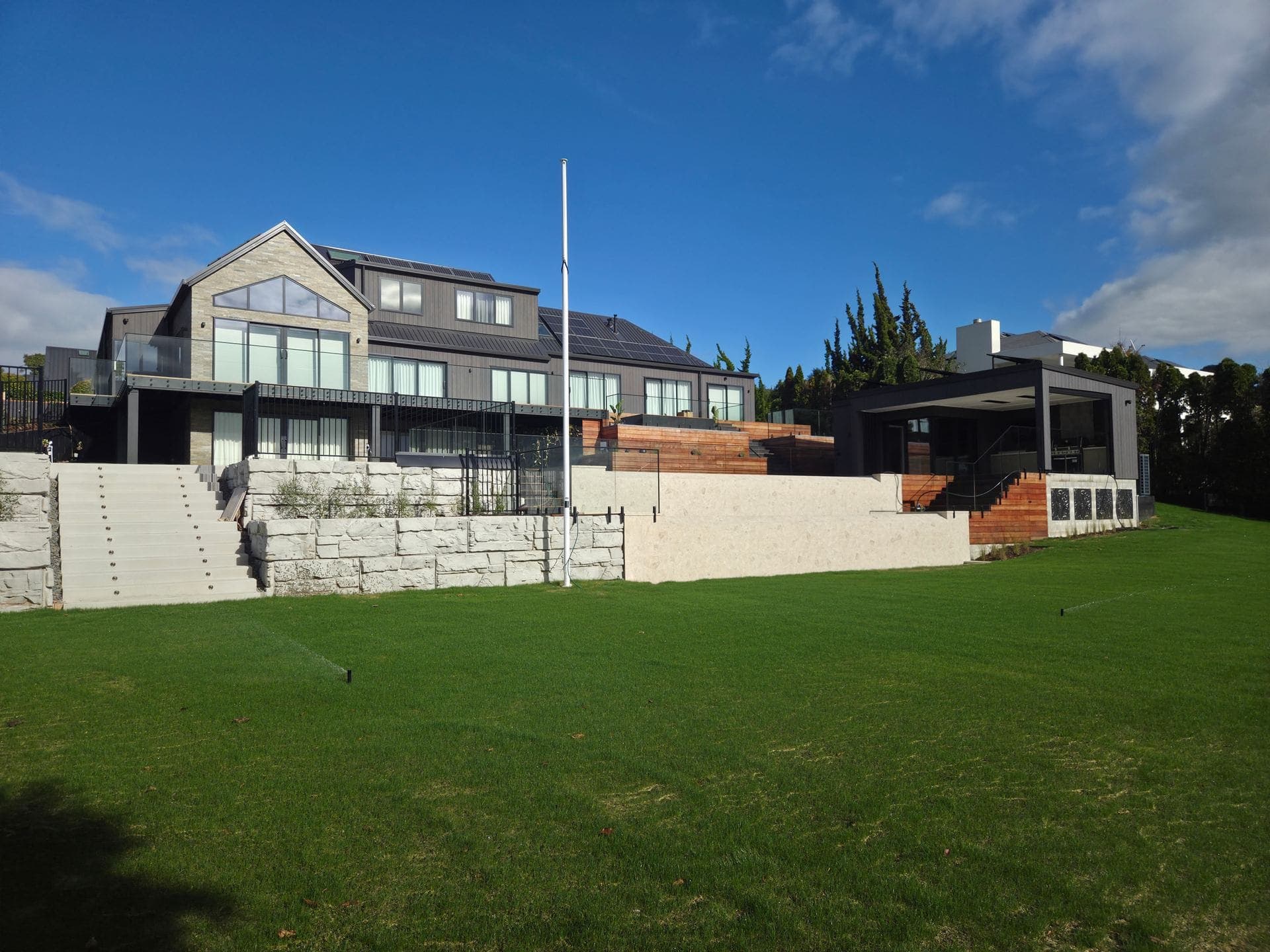 An established lawn on a Pukete property, with irrigation heads visible - lawn and garden work by Tensen Landscapes