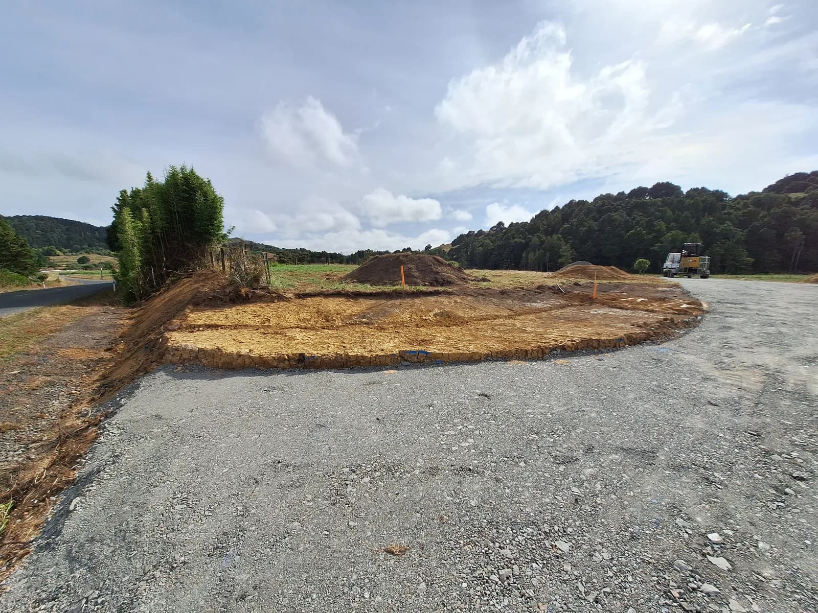 A cut and cleared building platform on a rural Waikato section, spoil piles either side, before anything gets built on it