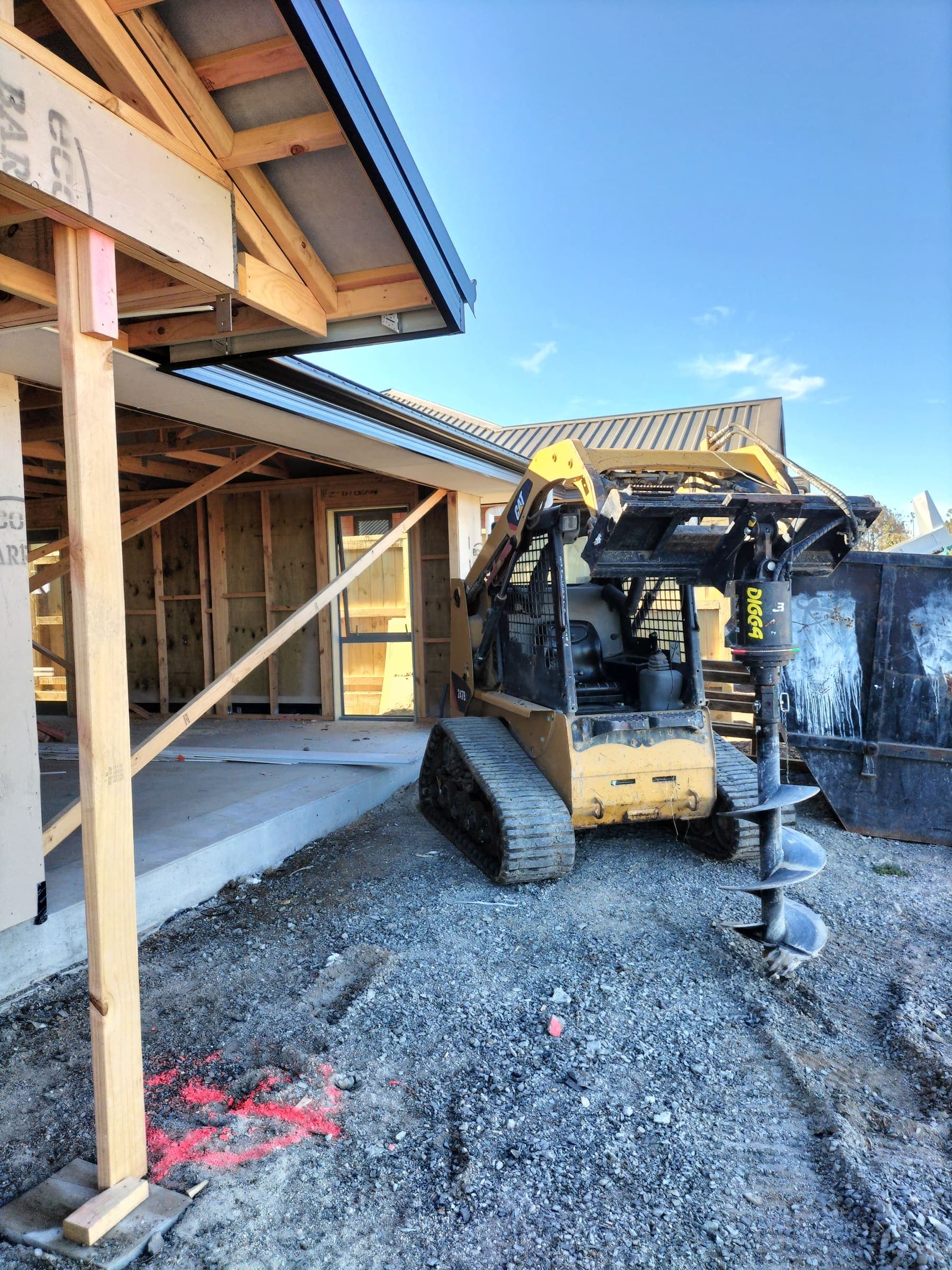 Post-hole auger attachment on site at a Hamilton new build