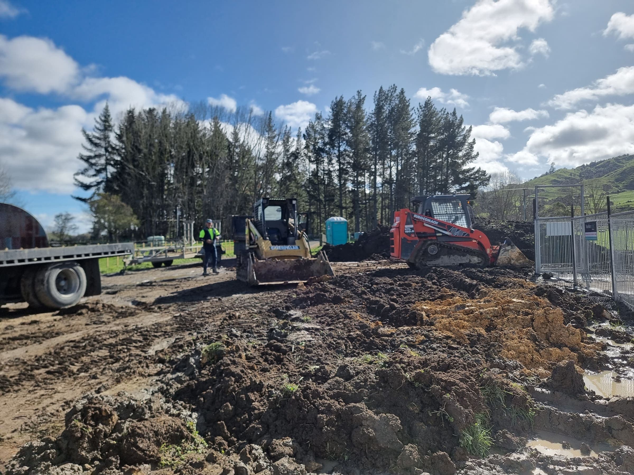 Two skid steers working a commercial earthworks site in the Waikato