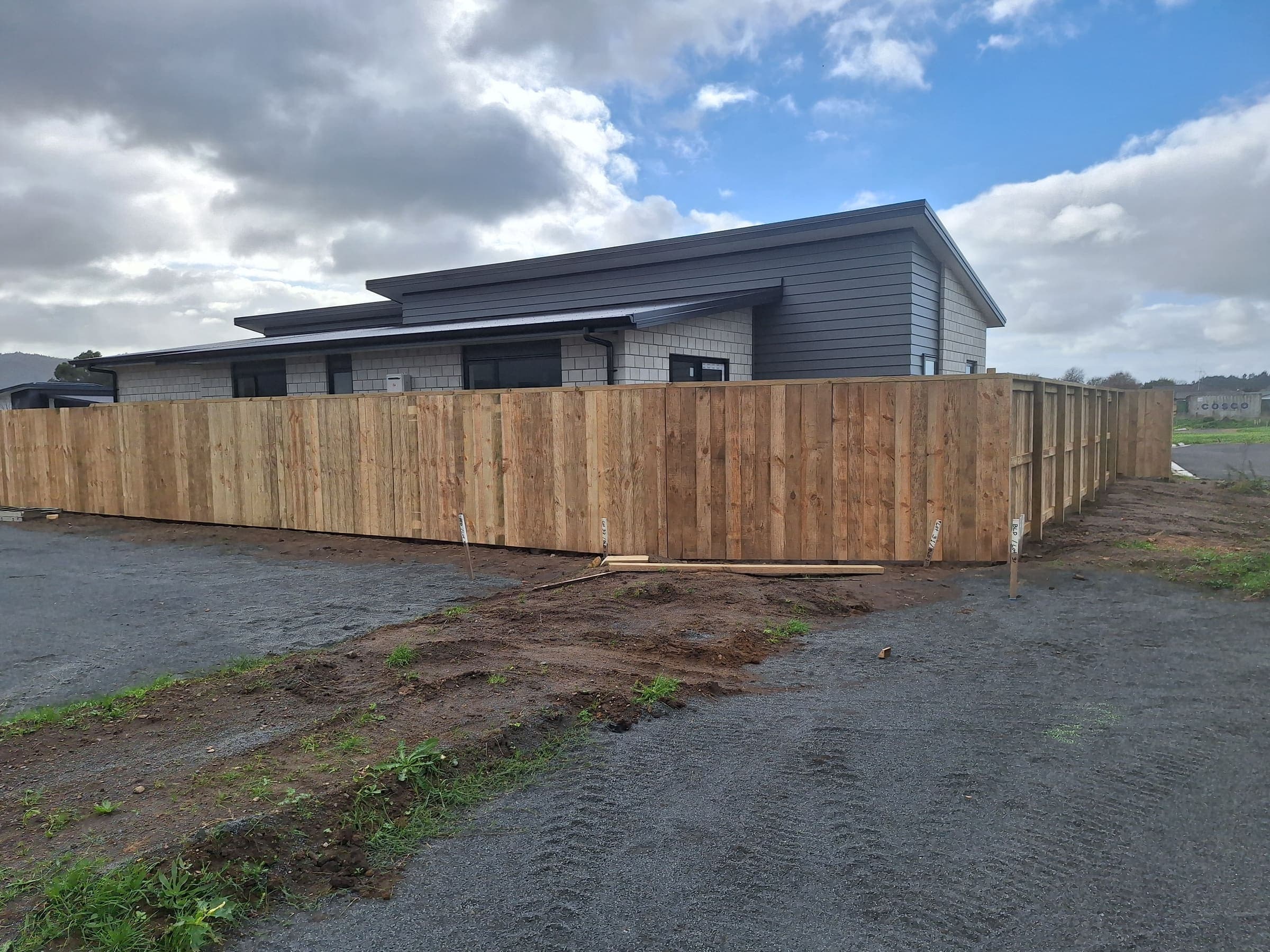 Timber paling fence enclosing a new Hamilton build