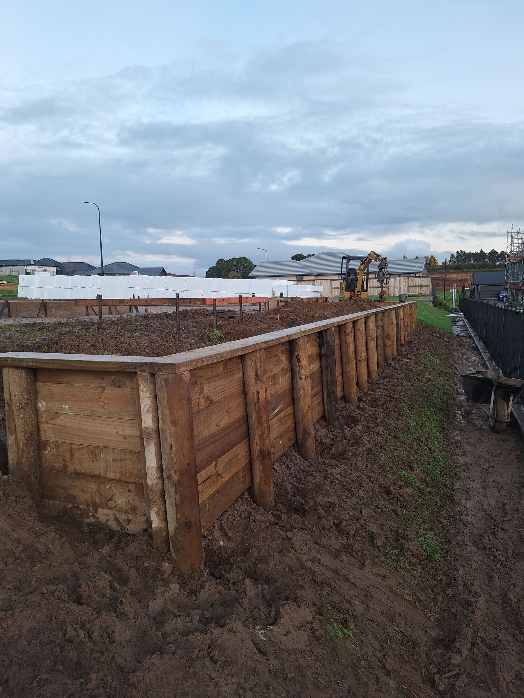 Large timber retaining wall being built on a Hamilton section